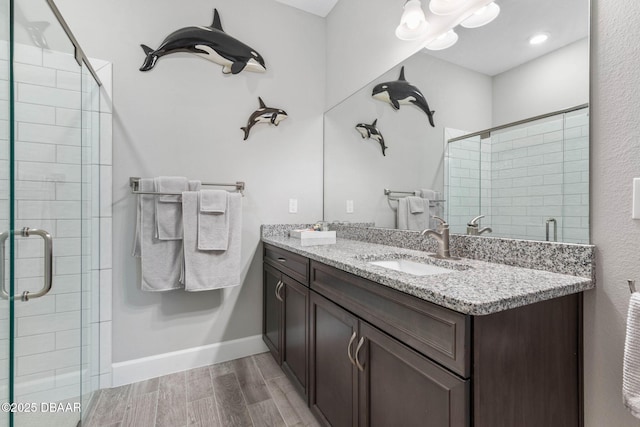 5 Chippeway Ct, Palm Coast, FL 32137 - full bath with a stall shower, double vanity, wood finished floors, and baseboards