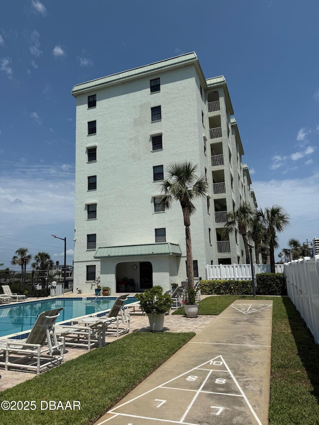 3800 S Atlantic Ave Unit 2010, Daytona Beach Shores, FL 32118 - surrounding community with fence, a pool, shuffleboard, and a patio area