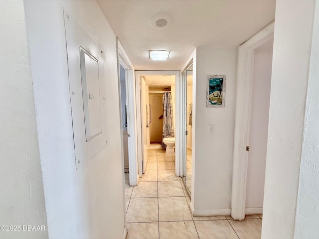 3800 S Atlantic Ave Unit 2010, Daytona Beach Shores, FL 32118 - corridor with light tile patterned floors, electric panel, and baseboards