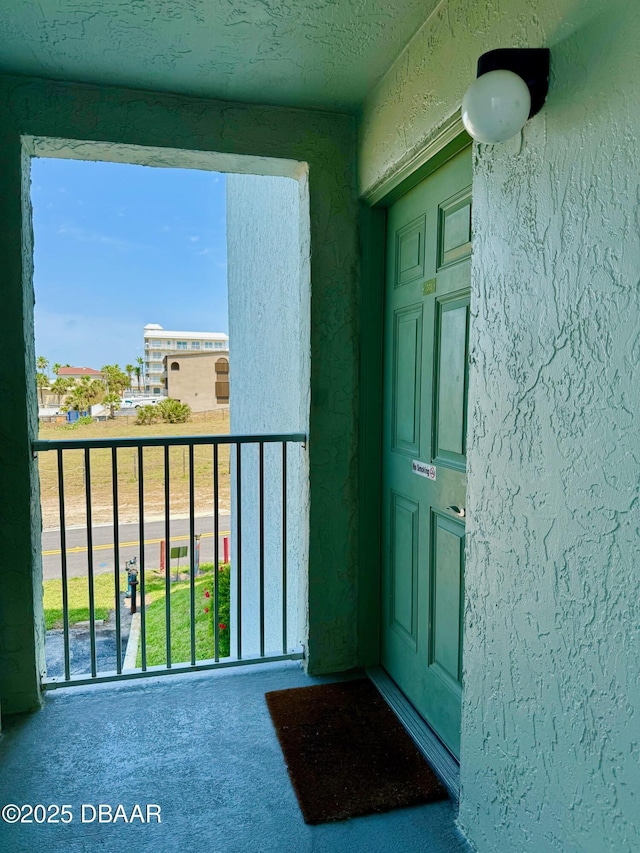 3800 S Atlantic Ave Unit 2010, Daytona Beach Shores, FL 32118 - doorway to property featuring stucco siding and a balcony