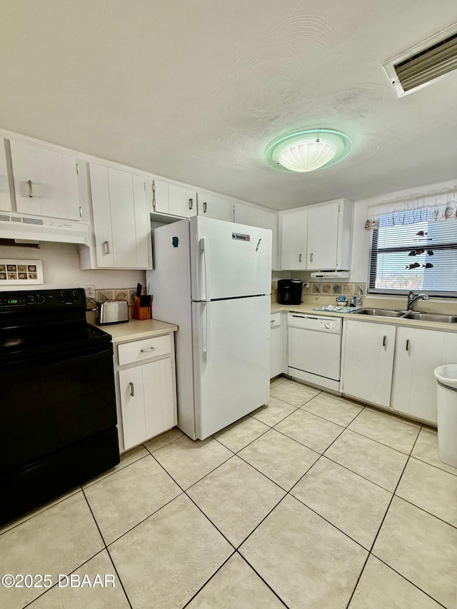 3800 S Atlantic Ave Unit 2010, Daytona Beach Shores, FL 32118 - kitchen with white appliances, a sink, under cabinet range hood, light countertops, and white cabinets