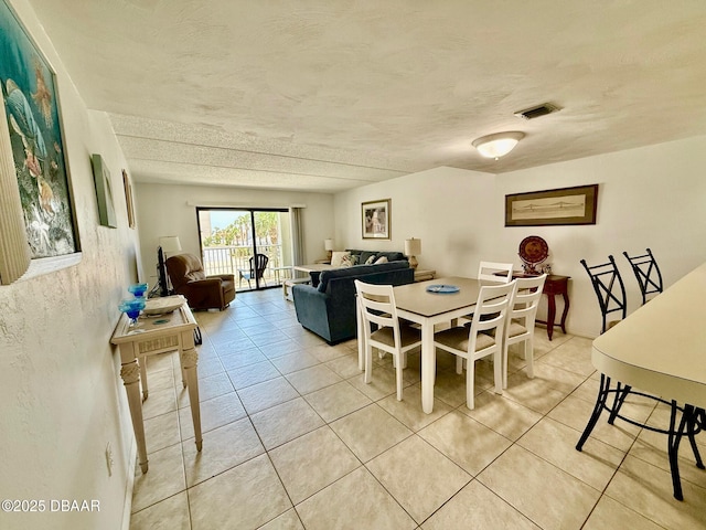 3800 S Atlantic Ave Unit 2010, Daytona Beach Shores, FL 32118 - dining space featuring light tile patterned flooring and a textured ceiling