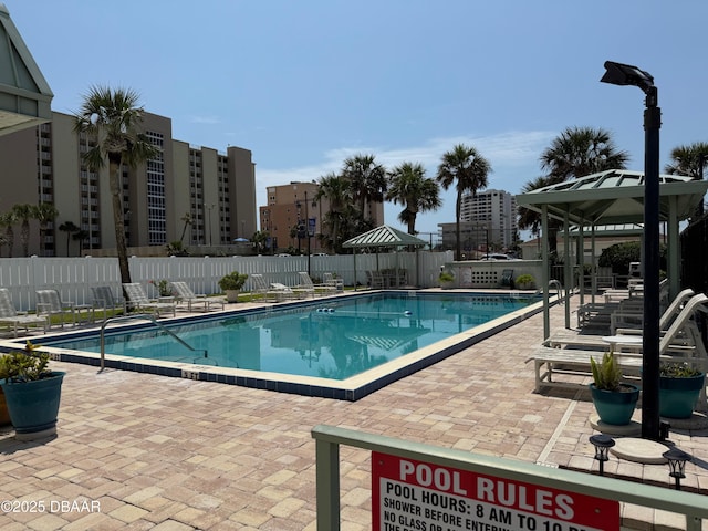 3800 S Atlantic Ave Unit 2010, Daytona Beach Shores, FL 32118 - community pool featuring a gazebo, a fenced backyard, and a patio