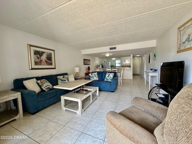 3800 S Atlantic Ave Unit 2010, Daytona Beach Shores, FL 32118 - living room with light tile patterned flooring and a textured ceiling