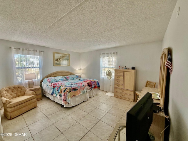 3800 S Atlantic Ave Unit 2010, Daytona Beach Shores, FL 32118 - bedroom with light tile patterned floors, a textured ceiling, and multiple windows