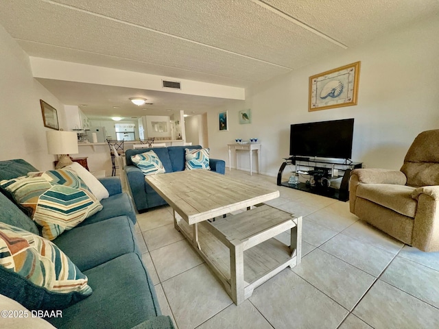 3800 S Atlantic Ave Unit 2010, Daytona Beach Shores, FL 32118 - living room featuring light tile patterned floors and a textured ceiling