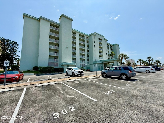 3800 S Atlantic Ave Unit 2010, Daytona Beach Shores, FL 32118 - view of apartment building / complex featuring uncovered parking