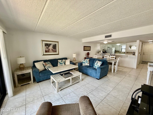 3800 S Atlantic Ave Unit 2010, Daytona Beach Shores, FL 32118 - living area featuring light tile patterned floors and a textured ceiling