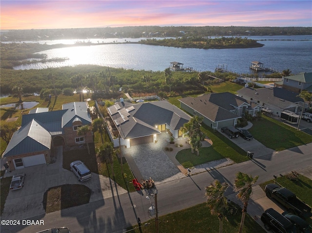 aerial view at dusk with a water view