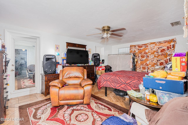 tiled bedroom with ceiling fan and a closet