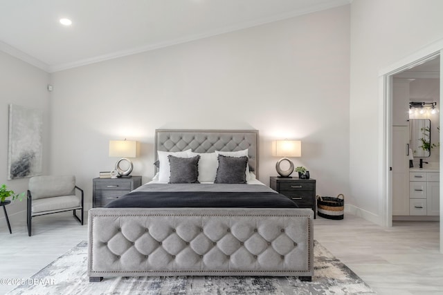 bedroom with light hardwood / wood-style flooring, connected bathroom, and ornamental molding