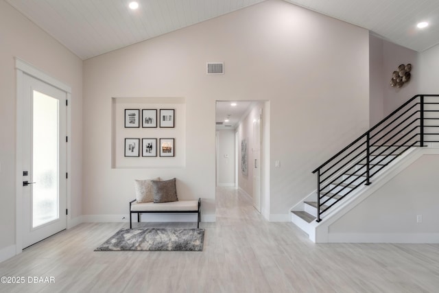 foyer with wooden ceiling, light hardwood / wood-style flooring, and high vaulted ceiling