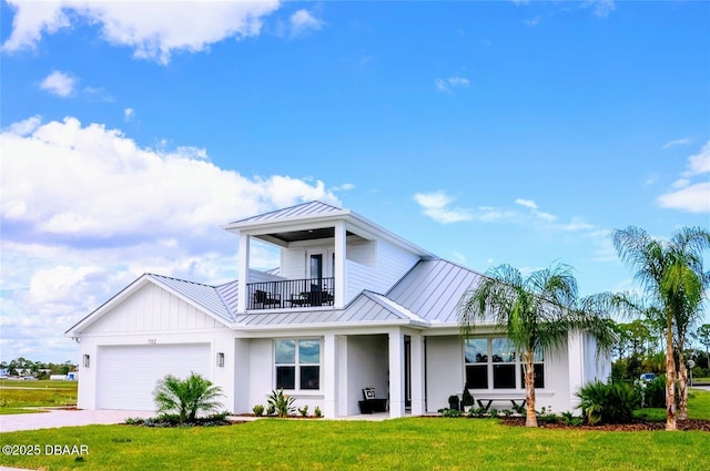 view of front of house featuring a balcony, a front yard, and a garage