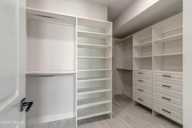 walk in closet featuring light hardwood / wood-style flooring