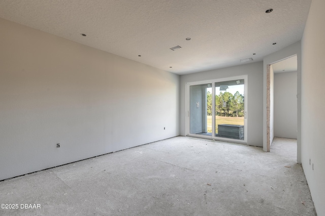 empty room featuring a textured ceiling