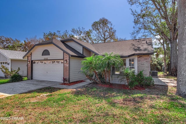 view of front of home featuring cooling unit, a garage, and a front lawn