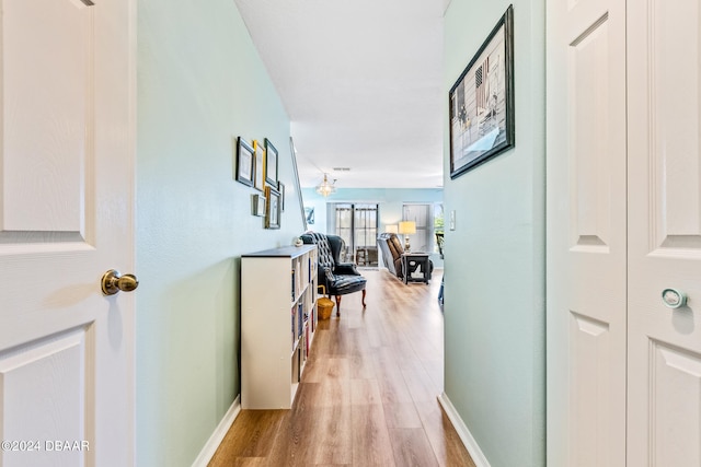 corridor with light hardwood / wood-style flooring