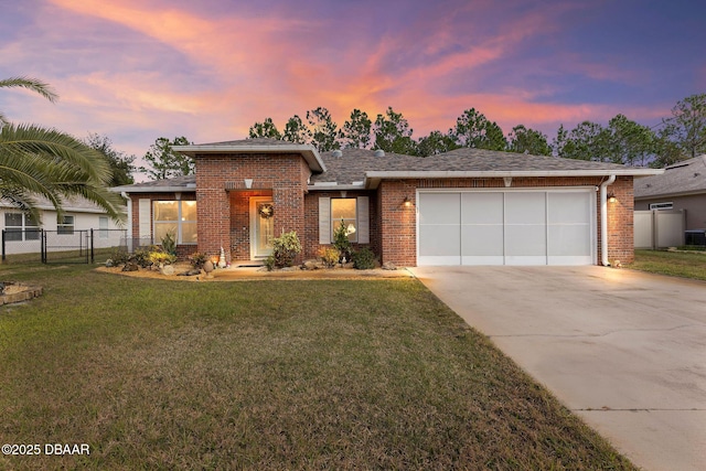 view of front facade with a garage and a yard