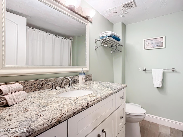 bathroom featuring toilet and vanity