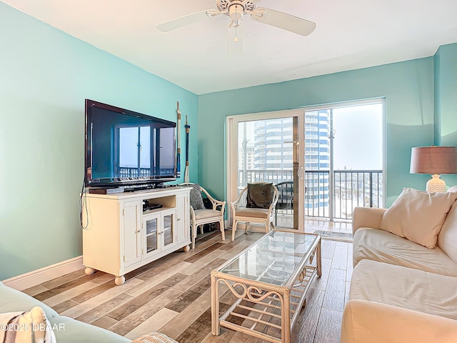 living room featuring light wood-type flooring and ceiling fan