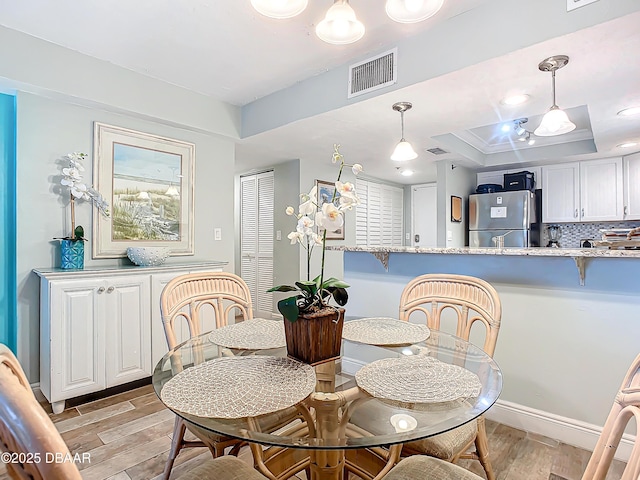 dining area featuring a raised ceiling