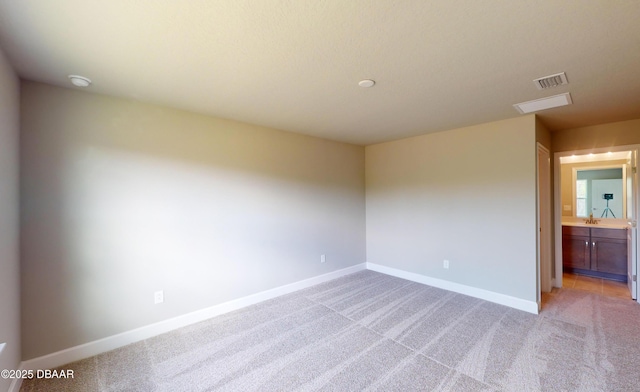 spare room with light colored carpet