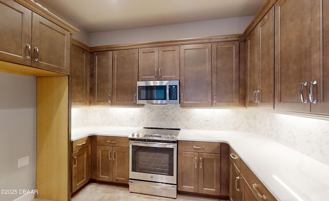 kitchen with decorative backsplash and appliances with stainless steel finishes