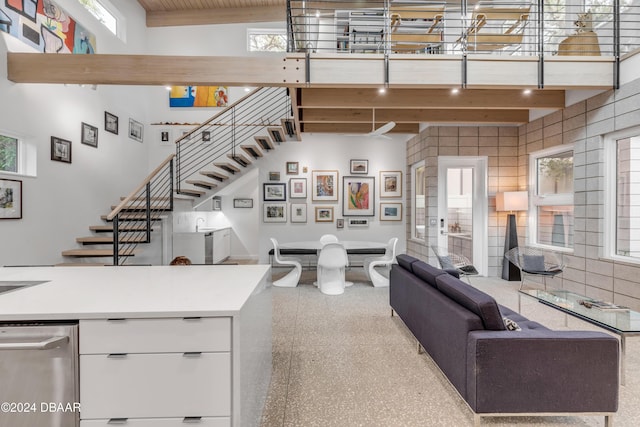 living room featuring plenty of natural light and high vaulted ceiling