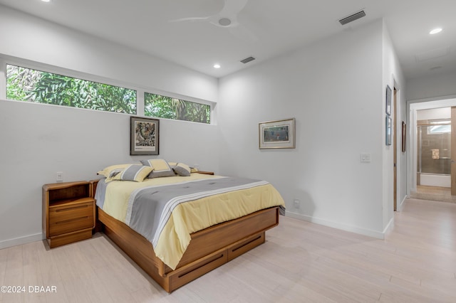 bedroom featuring ensuite bathroom, ceiling fan, and light hardwood / wood-style floors