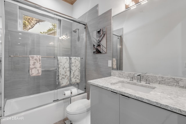 full bathroom with toilet, combined bath / shower with glass door, and vanity