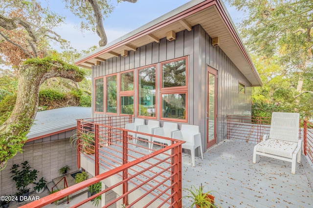 exterior space featuring a sunroom and a wooden deck