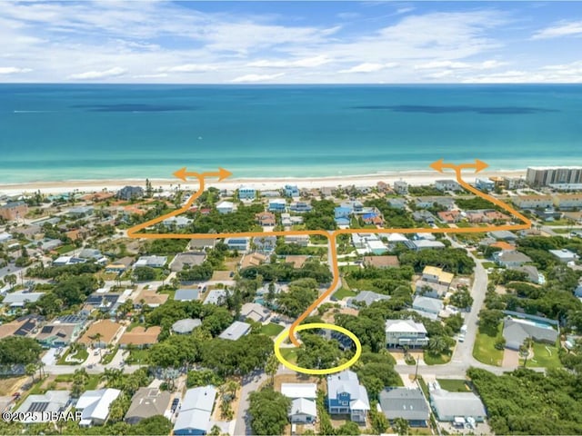 bird's eye view with a water view and a view of the beach