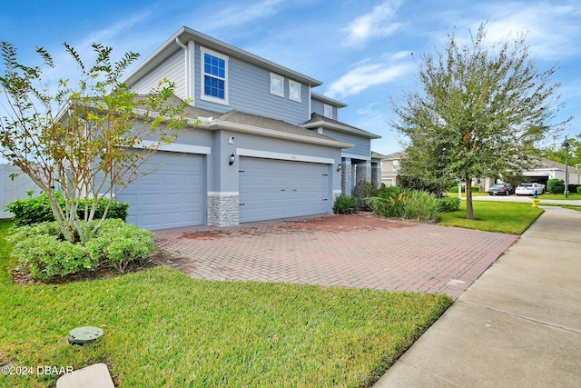 view of front of house featuring a front lawn and a garage