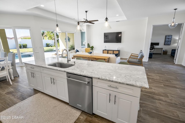 kitchen with pendant lighting, sink, dishwasher, a tray ceiling, and white cabinets