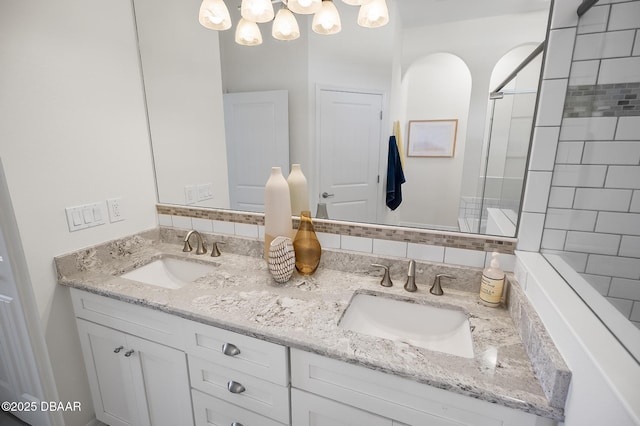 bathroom with vanity and tiled shower