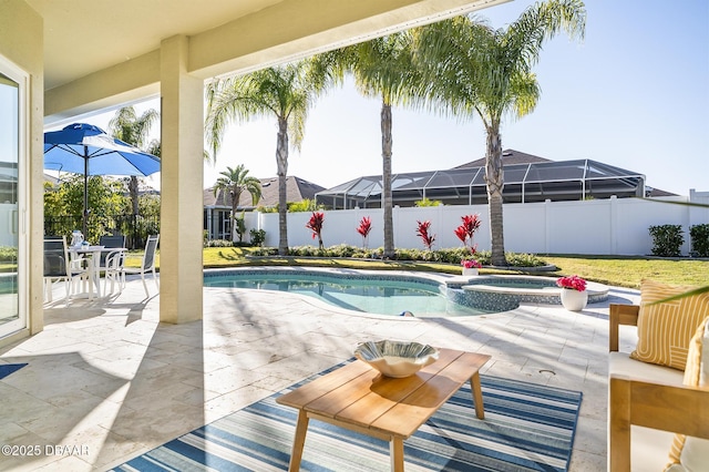 view of swimming pool featuring an in ground hot tub and a patio