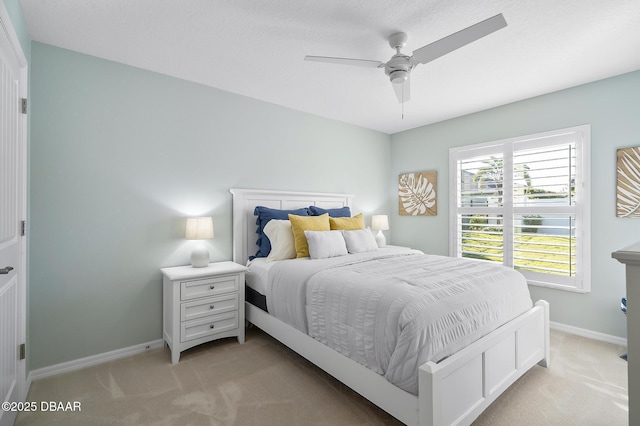 bedroom with ceiling fan and light colored carpet