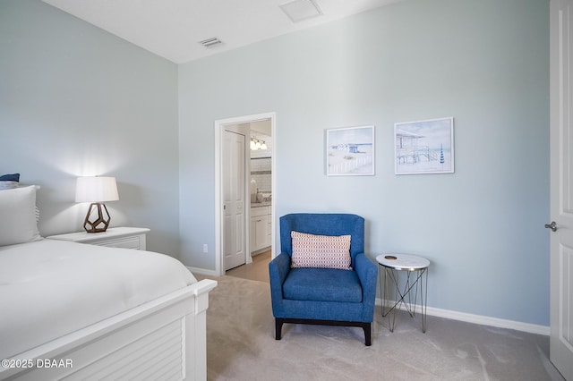 carpeted bedroom featuring ensuite bath