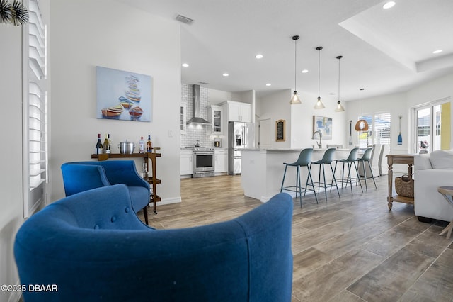 living room featuring sink and hardwood / wood-style floors