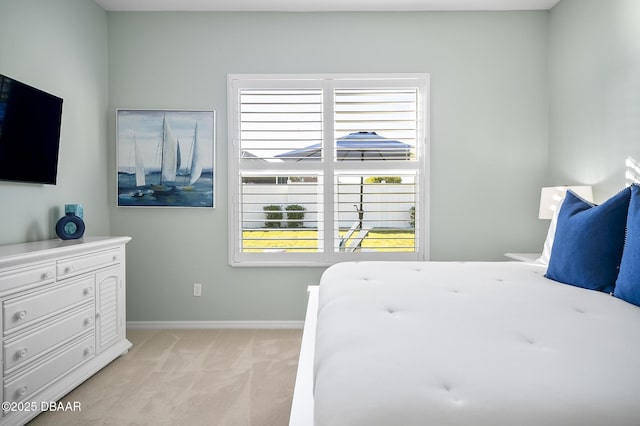 bedroom featuring light colored carpet