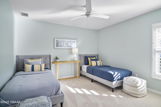 bedroom with ceiling fan and light carpet