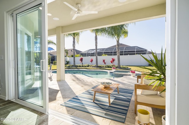 view of swimming pool featuring an in ground hot tub, ceiling fan, and a patio area