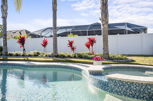 view of swimming pool with an in ground hot tub