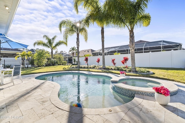 view of swimming pool featuring a yard, a patio, and an in ground hot tub