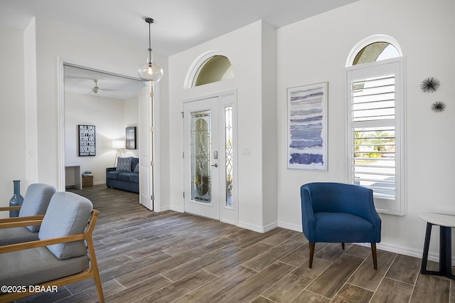 foyer featuring dark wood-type flooring and ceiling fan