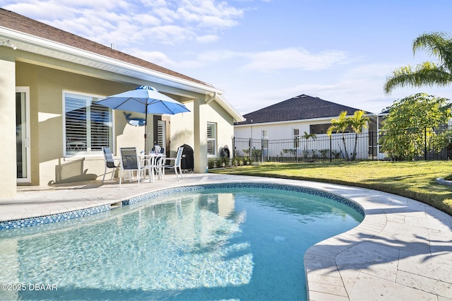 view of swimming pool with a lawn and a patio area