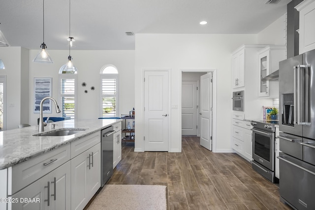 kitchen featuring dark hardwood / wood-style flooring, sink, white cabinets, and appliances with stainless steel finishes