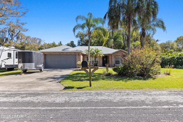 view of front of house with driveway, an attached garage, a front lawn, and brick siding