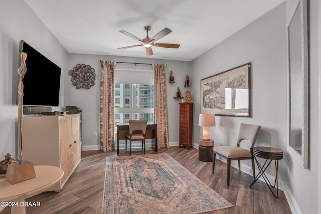 sitting room featuring dark hardwood / wood-style floors and ceiling fan