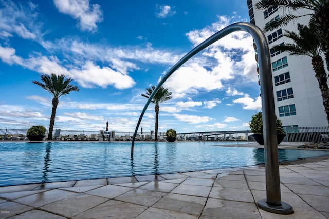 view of pool featuring a water view